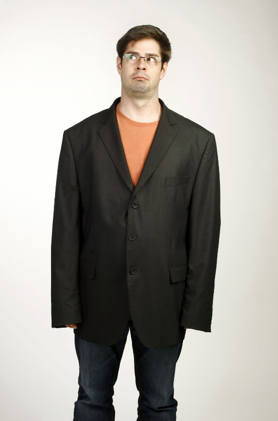 Man in oversized jacket with scared look